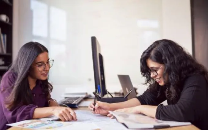 Two women working at a computer