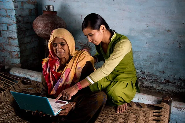 Two women learning on a laptop